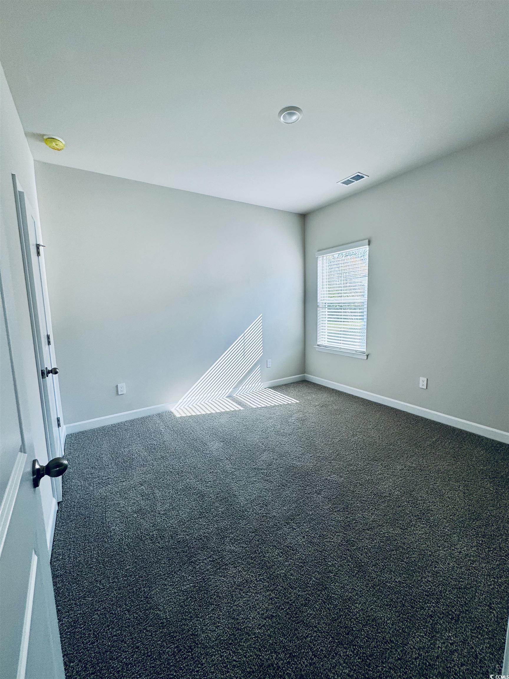 2032 Copper Crk Loop Longs, SC 29568 - Photo 8 of 36 Spare room featuring baseboards, visible vents, an