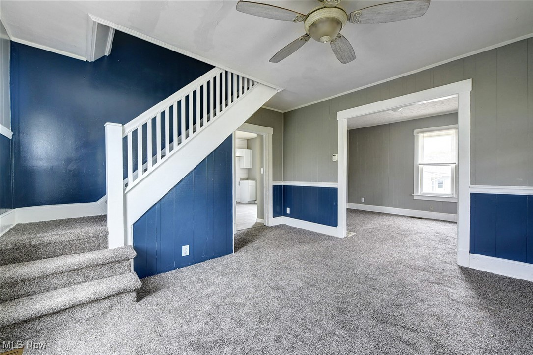 38780 Chestnut Ridge Road Elyria, OH 44035 - Photo 9 of 32 Unfurnished living room featuring carpet floors, ceiling fan, crown molding, and washer / clothes dryer