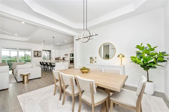 a living room with furniture a flat screen tv and kitchen view
