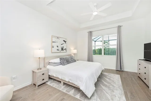 a bedroom with a bed and a chandelier