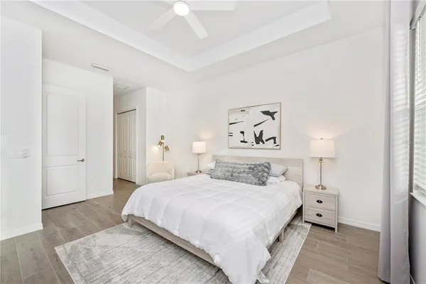 a bathroom with a sink a toilet a mirror a bathtub and shower