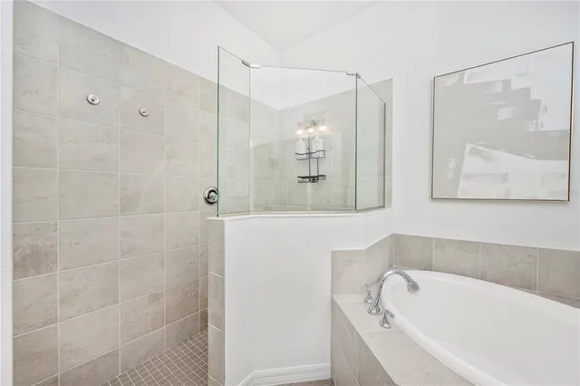a living room with a dining table and a potted plant