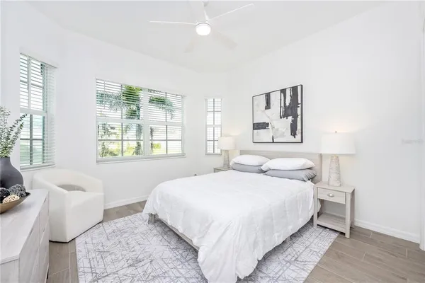 a living room with furniture a rug and a floor to ceiling window