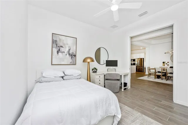 a view of a house with a big yard and large trees