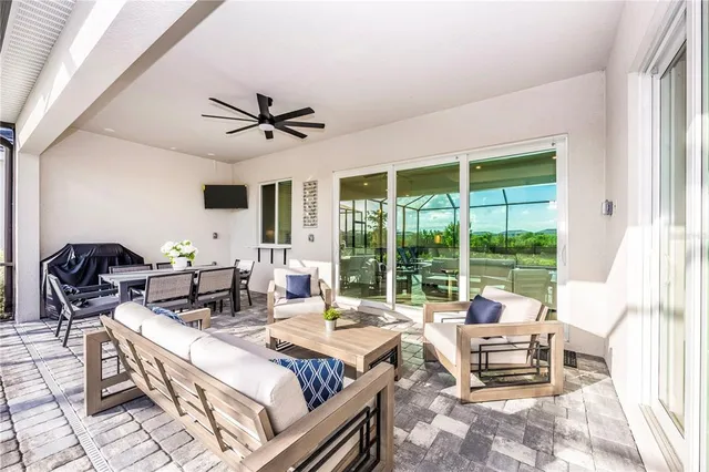 a front view of a house with glass windows and furniture