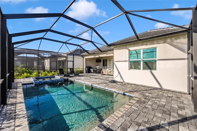 a view of a house with backyard porch and sitting area