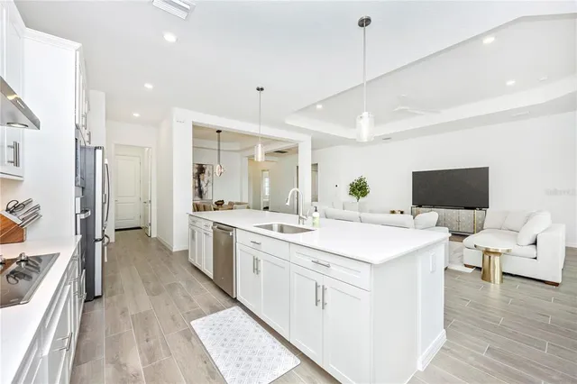 a living room with furniture a large window and a flat screen tv