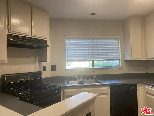 a view of staircase with wooden floor and white walls