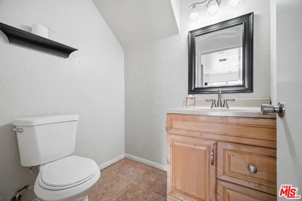 a bathroom with a sink toilet a mirror and shower
