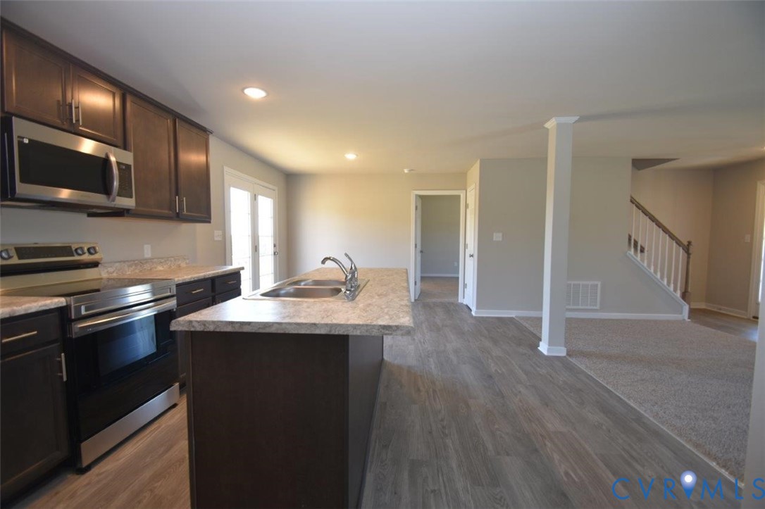 2570 Doctors Road Louisa, VA 23093 - Photo 11 of 17 a kitchen with stainless steel appliances granite countertop a sink stove and microwave