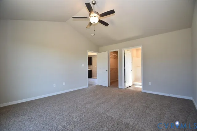 an empty room with closet and a ceiling fan