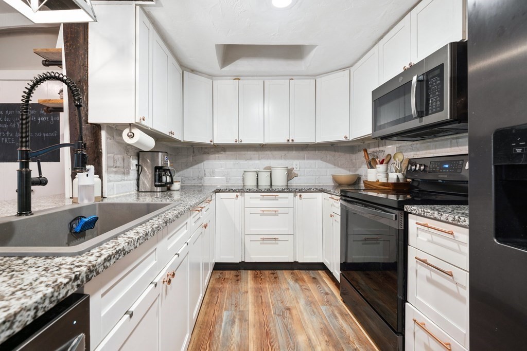 272 Harvard Road Bolton, MA 01740 - Photo 13 of 42 a kitchen with stainless steel appliances granite countertop a sink and stove top oven