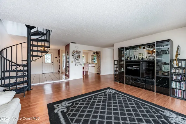 a room with wooden floor and furniture