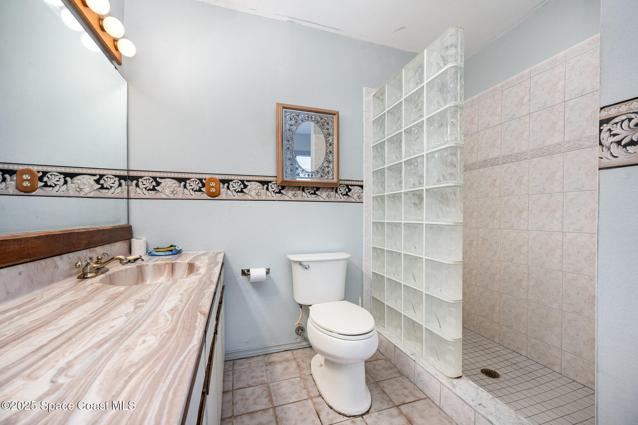 1635 Sandpiper Street Merritt Island, FL 32952 - Photo 21 of 31 a bathroom with a toilet sink and shower