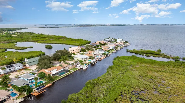 a living room with couch floor to ceiling window and a wooden floor