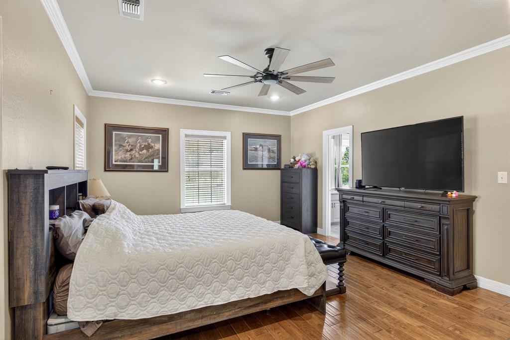 482 Center Hill Road Gainesville, TX 76240 - Photo 12 of 38 a bedroom with a bed and a flat screen tv
