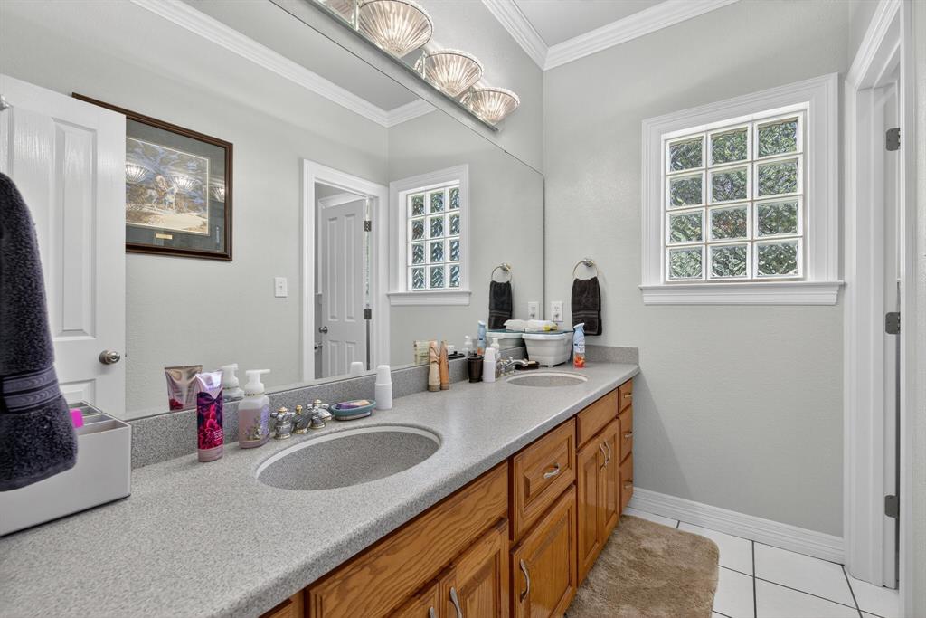 482 Center Hill Road Gainesville, TX 76240 - Photo 16 of 38 a bathroom with a sink double vanity and a mirror