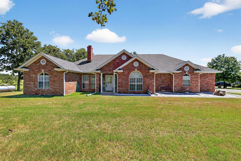 482 Center Hill Road Gainesville, TX 76240 - Photo 2 of 38 a front view of a house with a garden