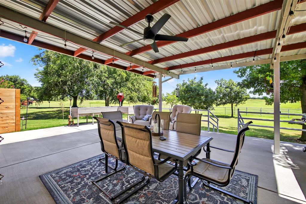 482 Center Hill Road Gainesville, TX 76240 - Photo 22 of 38 a view of a patio with a table chairs and a backyard