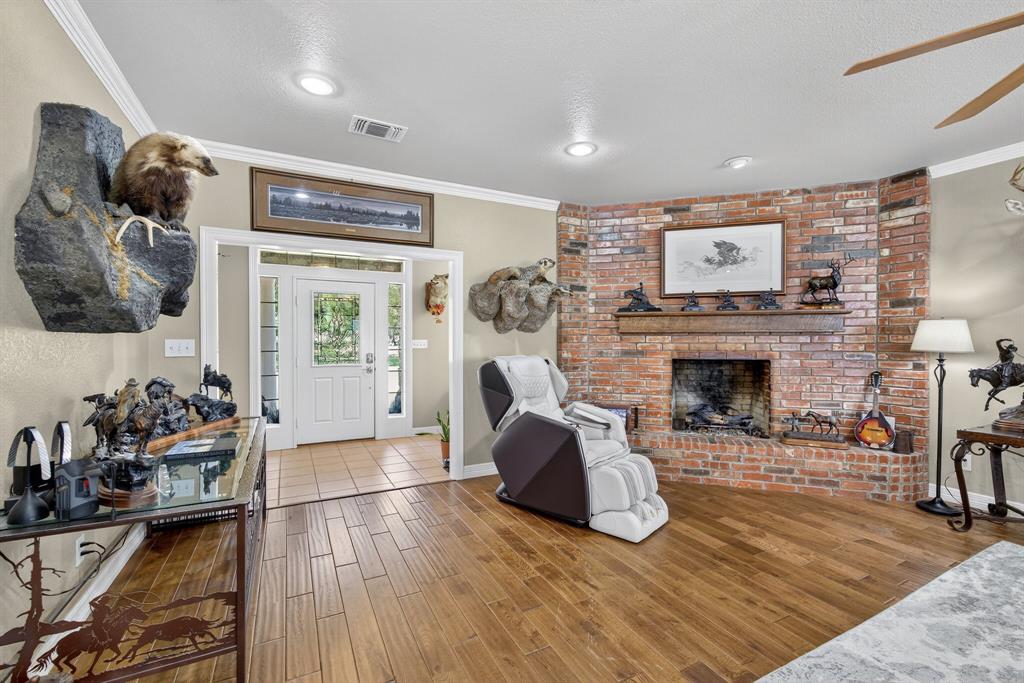 482 Center Hill Road Gainesville, TX 76240 - Photo 3 of 38 a living room with furniture and a fireplace