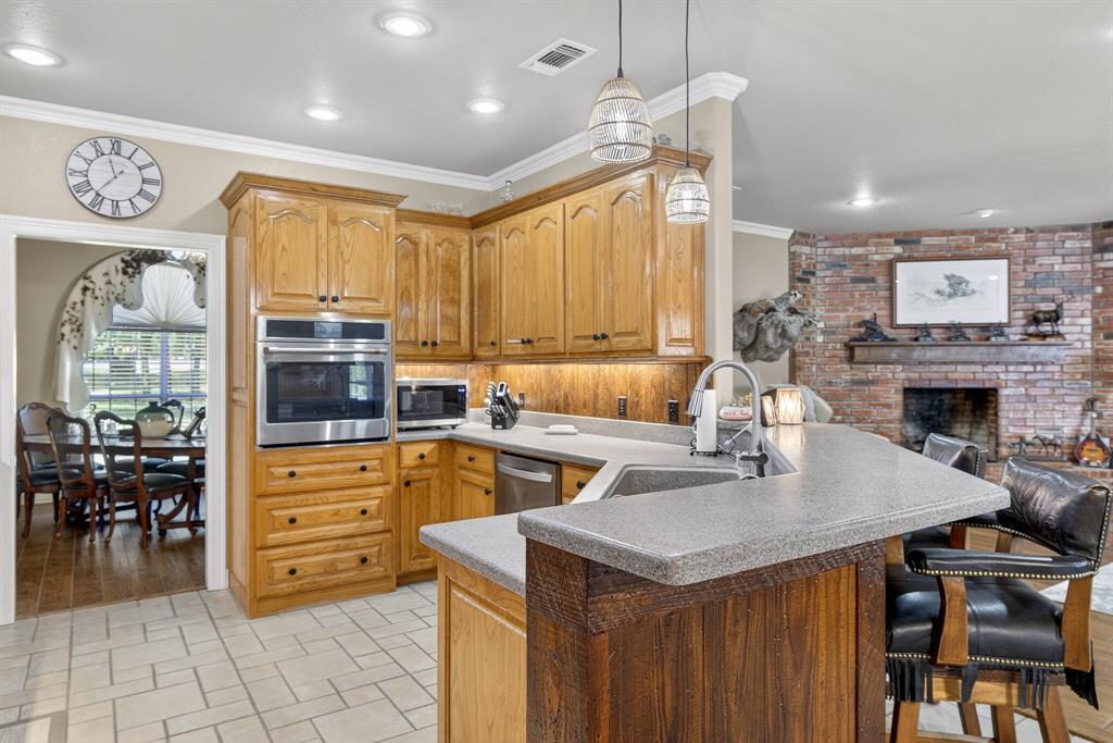 482 Center Hill Road Gainesville, TX 76240 - Photo 7 of 38 a open kitchen with stainless steel appliances granite countertop a stove and a refrigerator