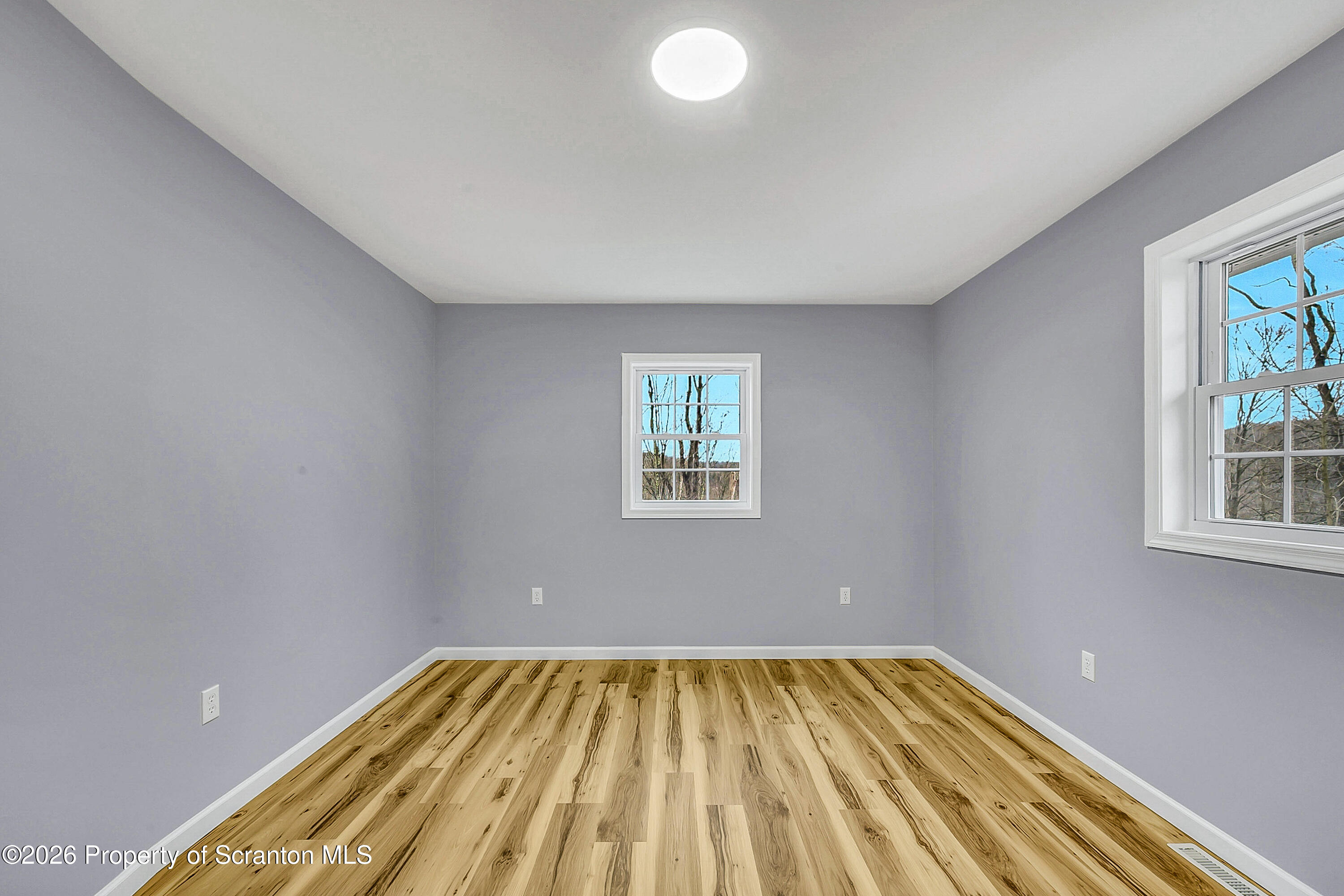 460 Newcomb Road Factoryville, PA 18419 - Photo 18 of 40 a view of empty room with wooden floor and fan