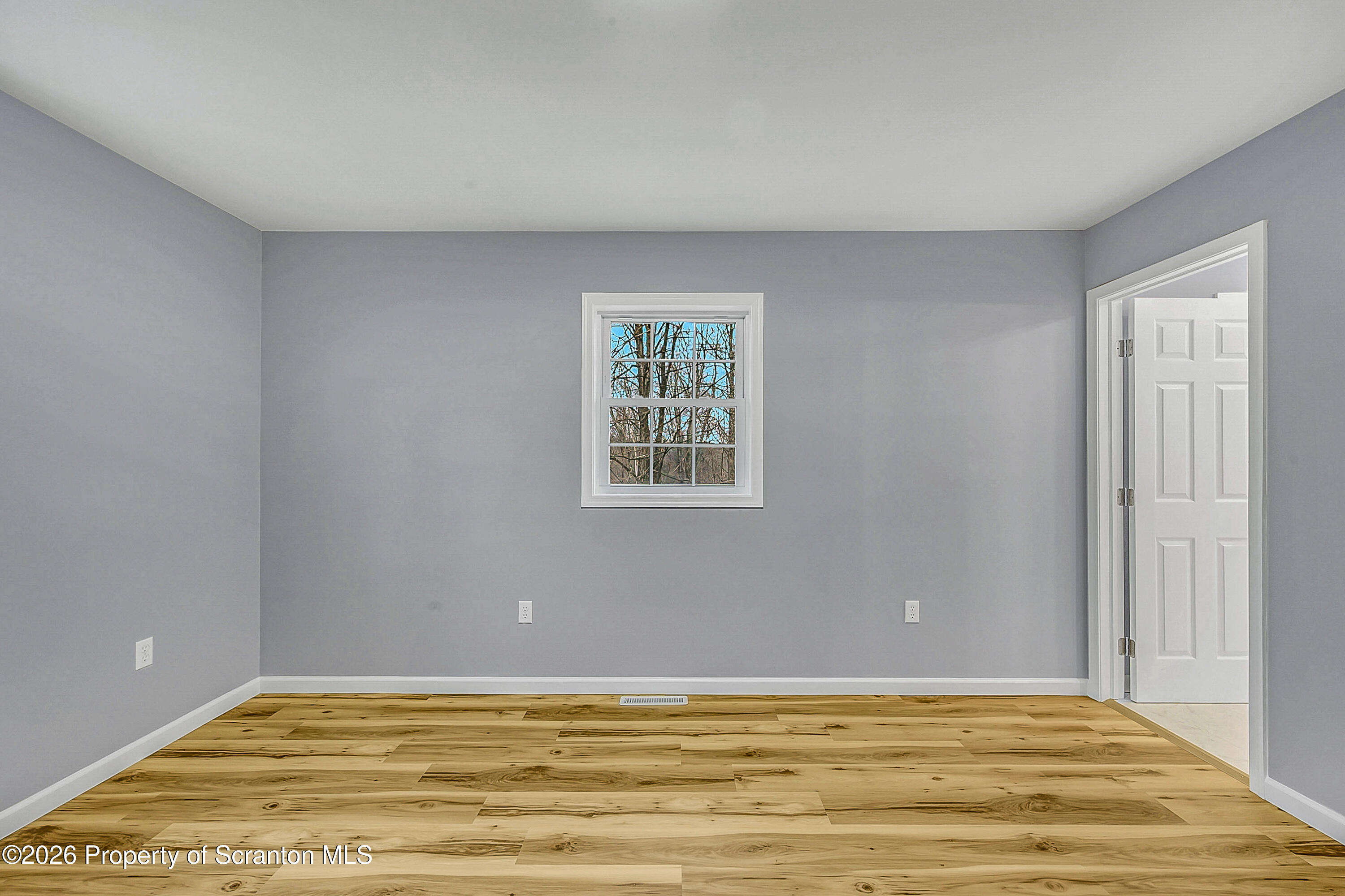 460 Newcomb Road Factoryville, PA 18419 - Photo 20 of 40 a view of an empty room with window and wooden floor