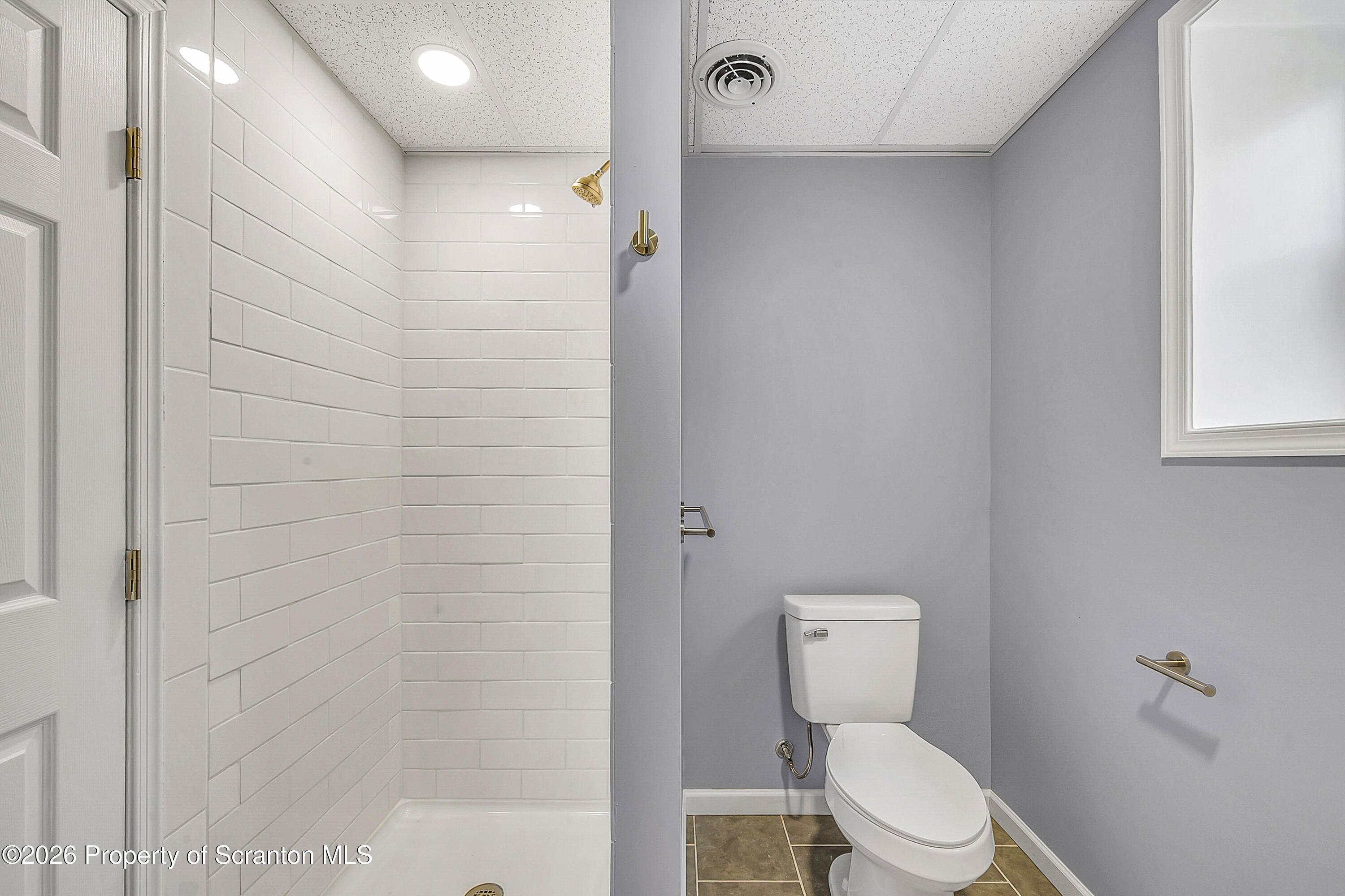 460 Newcomb Road Factoryville, PA 18419 - Photo 24 of 40 a bathroom with a toilet a sink and shower