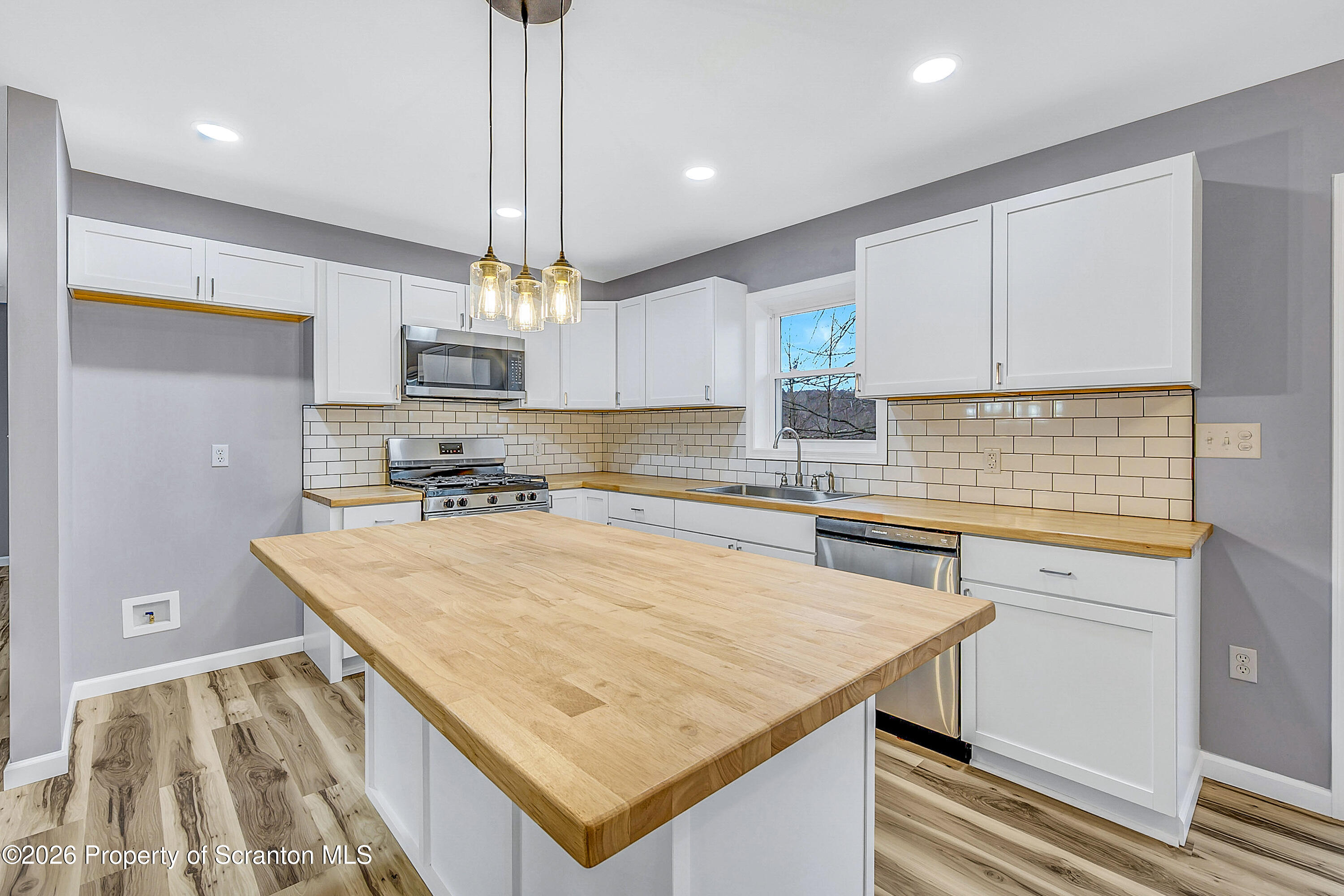 460 Newcomb Road Factoryville, PA 18419 - Photo 4 of 40 a kitchen with a sink a counter top space cabinets and appliances