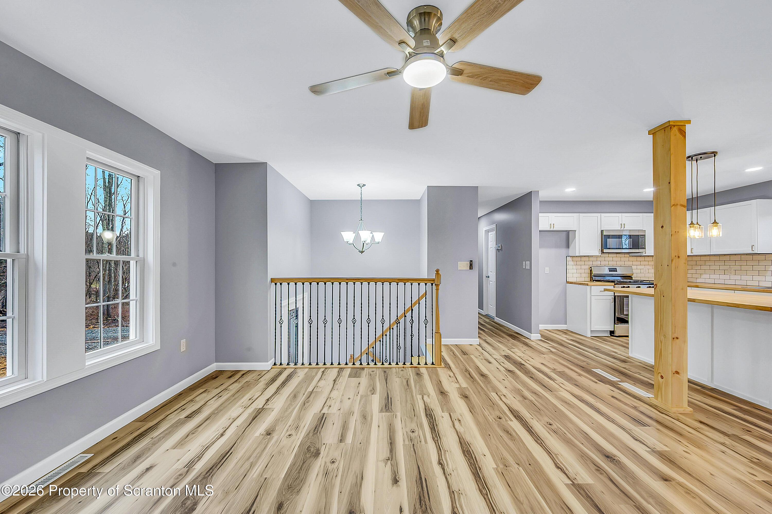 460 Newcomb Road Factoryville, PA 18419 - Photo 7 of 40 a view of a room with wooden floor a ceiling fan and windows