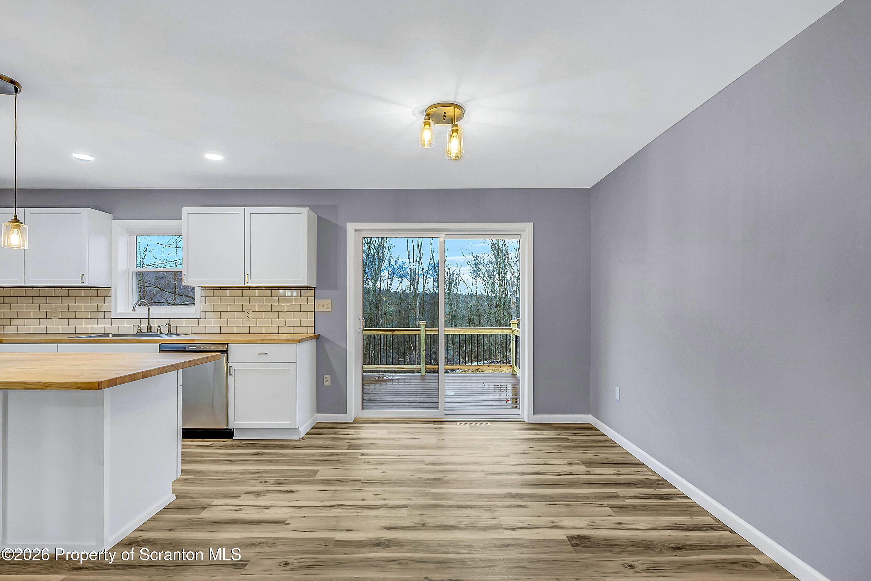 460 Newcomb Road Factoryville, PA 18419 - Photo 8 of 40 a view of a kitchen with a sink and dishwasher kitchen view with wooden floor