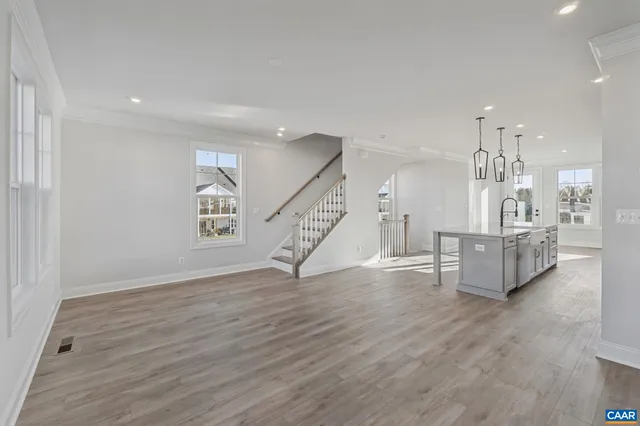 a view of a kitchen with furniture and wooden floor