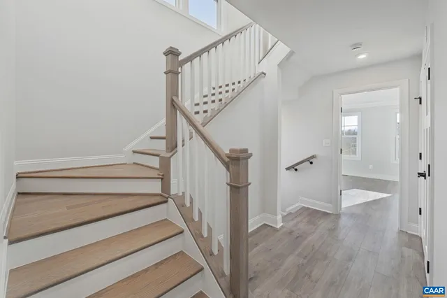 a view of entryway with wooden floor and stairs