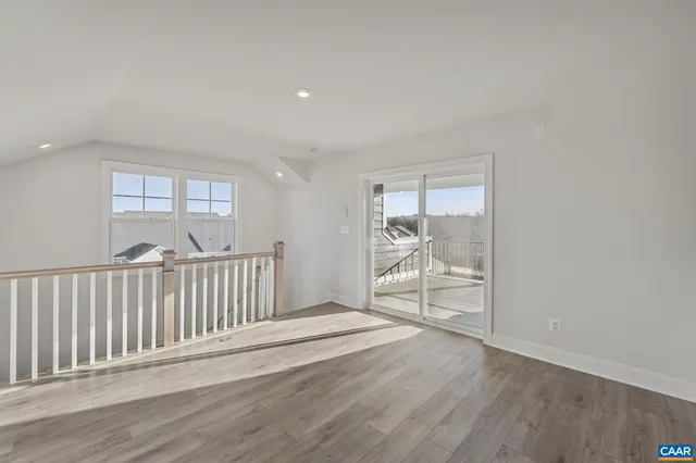 a view of a room with wooden floor and a window