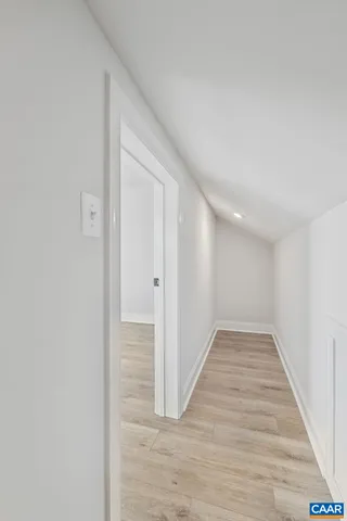 a view of an empty room and wooden floor