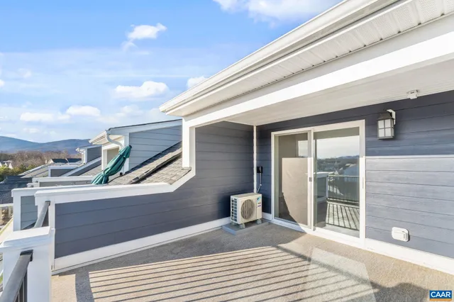 a view of a chair and tables in the balcony