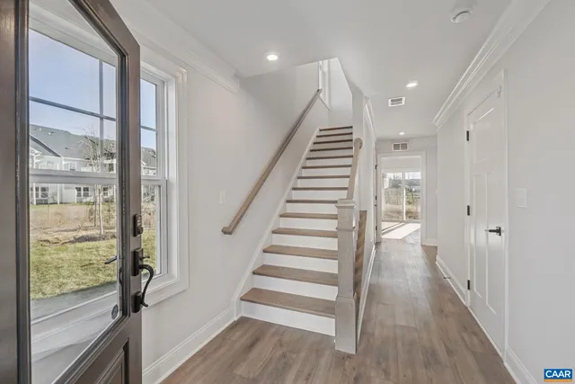 a view of entryway with wooden floor and stairs