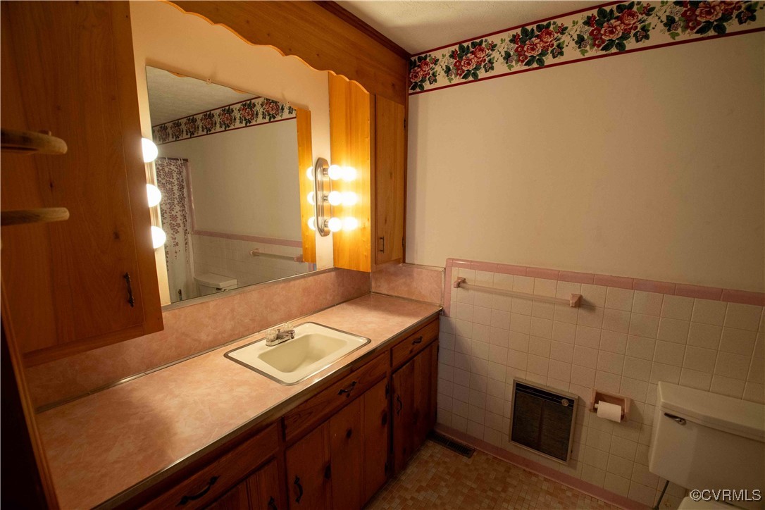 2600 Brunswick Road Blackstone, VA 23824 - Photo 11 of 35 Bathroom with vanity, toilet, heating unit, and ti