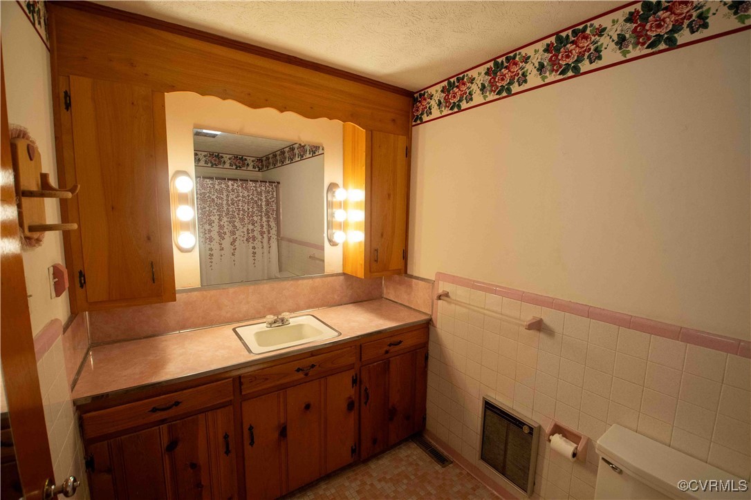 2600 Brunswick Road Blackstone, VA 23824 - Photo 30 of 35 Bathroom with vanity, a textured ceiling, a shower