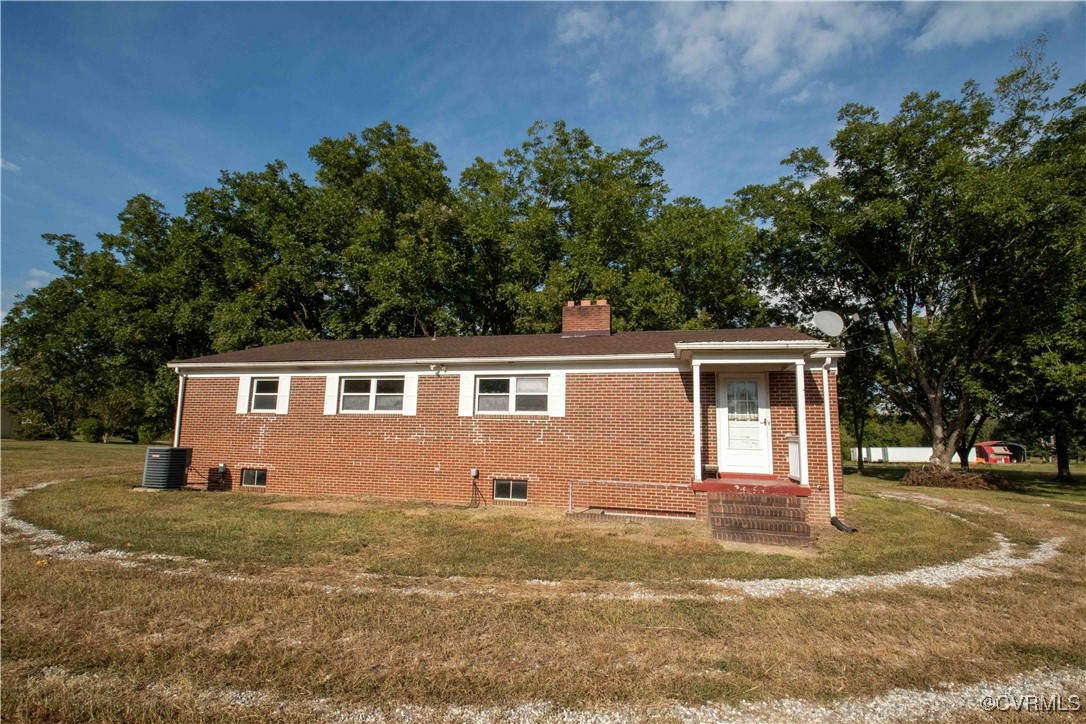 View of side of home featuring central AC unit and