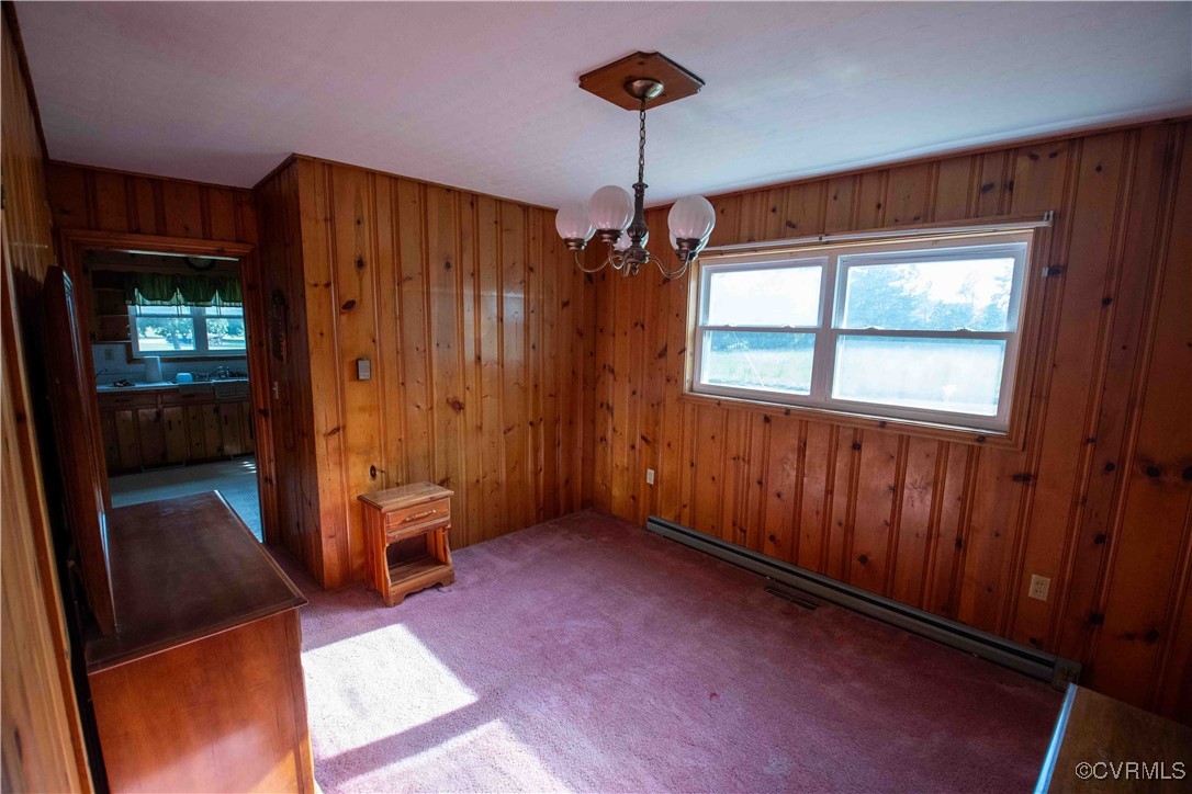 Unfurnished dining area with baseboard heating, a