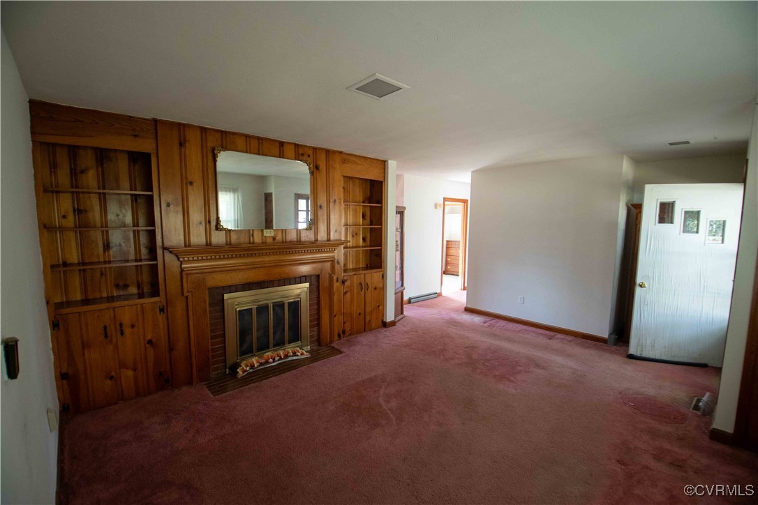 2600 Brunswick Road Blackstone, VA 23824 - Photo 9 of 35 Unfurnished living room with a fireplace and carpe