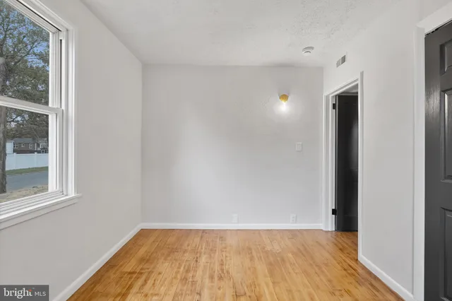 a view of a room with wooden floor and windows