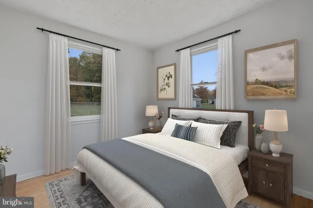 a bedroom with a bed and a painting on the wall