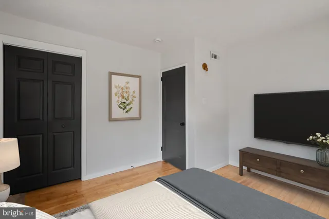 a bedroom with a bed and a flat screen tv