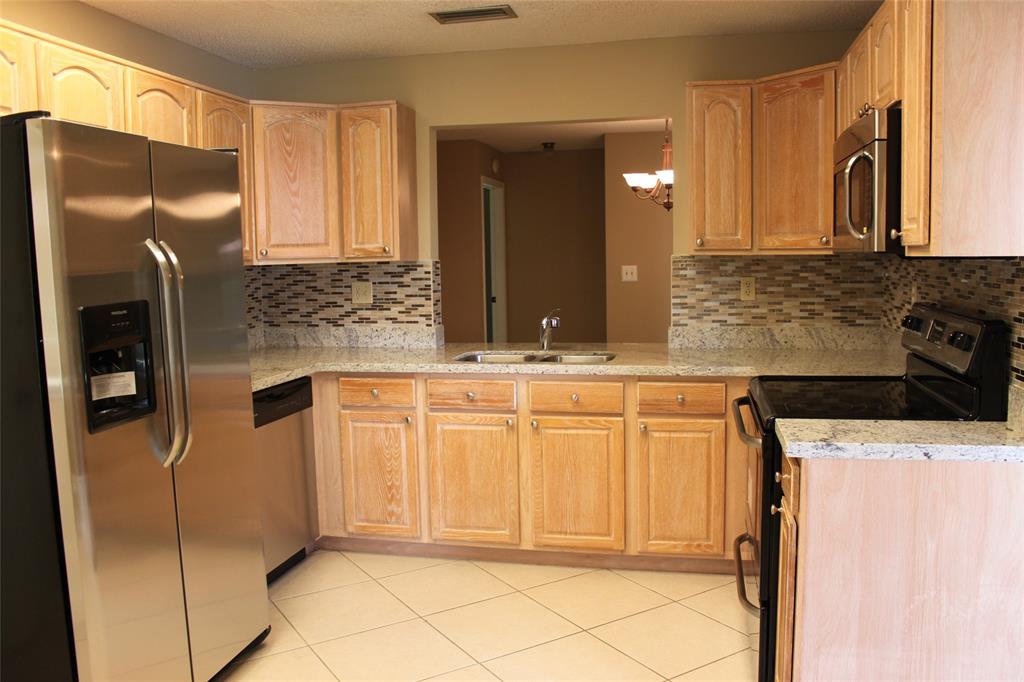 7044 Lantana Lane Tamarac, FL 33321 - Photo 1 of 7 a bathroom with a granite countertop sink and a mirror