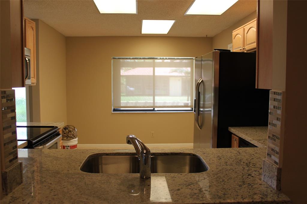 7044 Lantana Lane Tamarac, FL 33321 - Photo 2 of 7 a bathroom with a tub sink and mirror