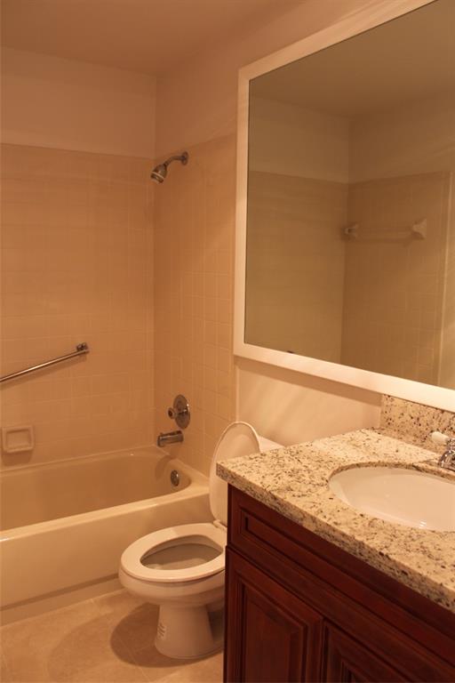 7044 Lantana Lane Tamarac, FL 33321 - Photo 6 of 7 a bathroom with a granite countertop bathtub toilet and sink