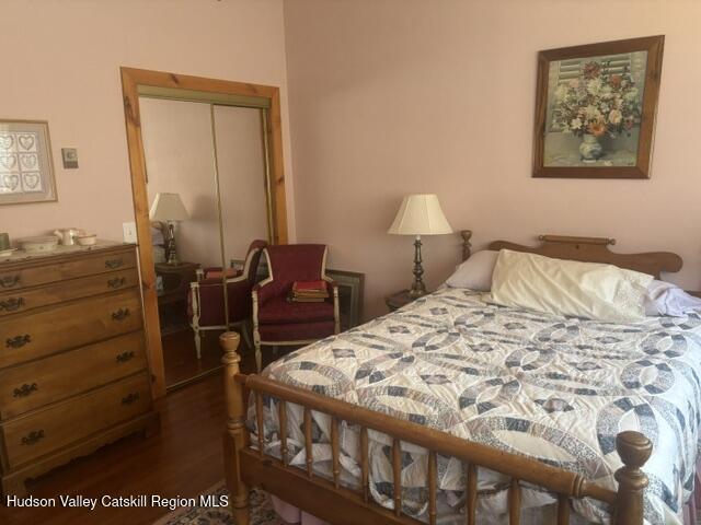119 South Mountain Road Gilboa, NY 12076 - Photo 13 of 24 a bed sitting in a bedroom next to a window