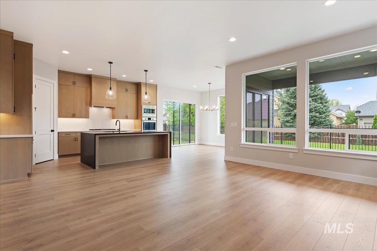 1297 West Malbar Street Meridian, ID 83646 - Photo 13 of 34 Open-concept living area featuring light wood-finish flooring